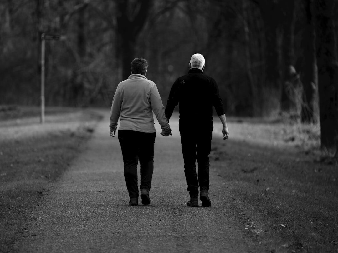 elderly couple walking in park