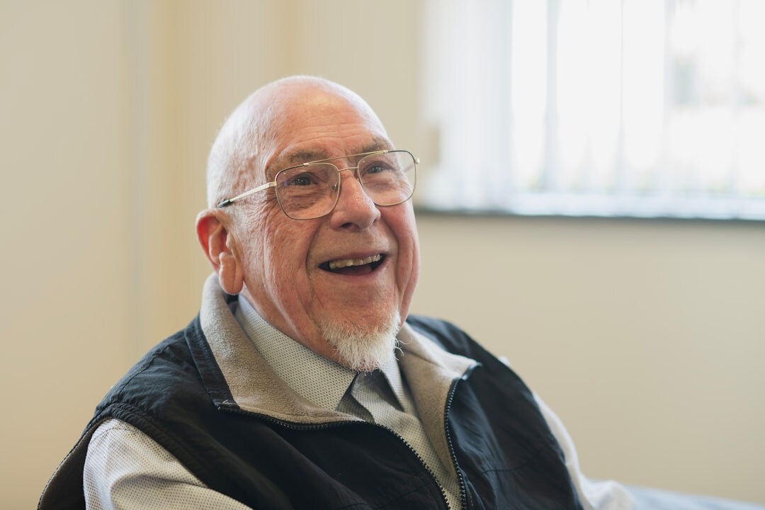 elderly man smiling with friends
